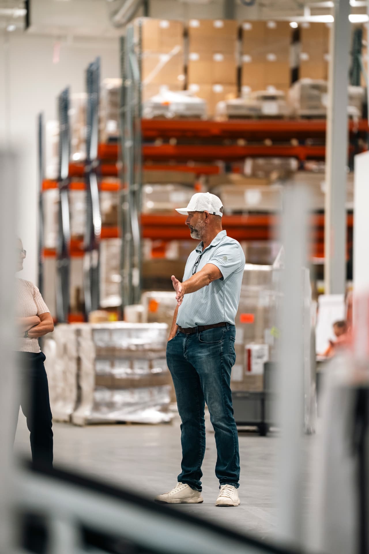 Bauer-Build team discussing plans inside an active warehouse facility